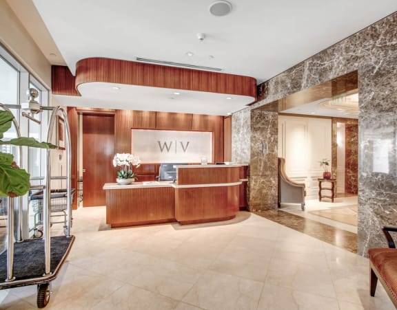 a lobby with a reception desk and a large window
