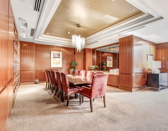 a dining room with wood paneling and a table and chairs