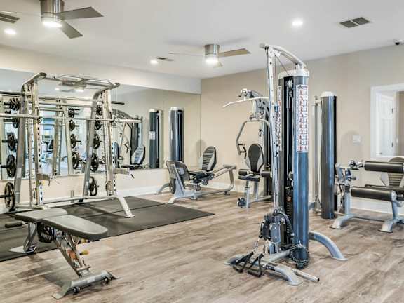 A well-equipped gym with a variety of machines and weightlifting equipment at Heritage at the Peak, Asheville, 28804
