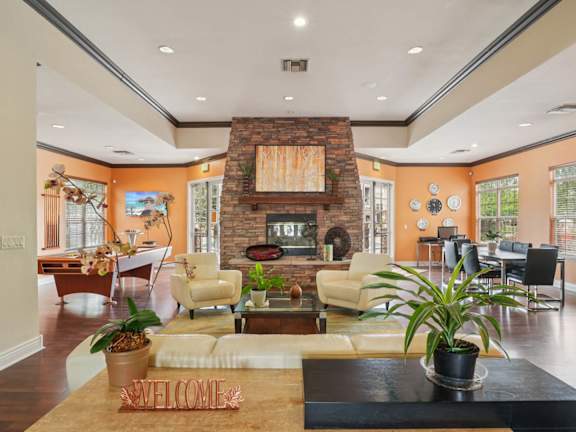 A living room with a fireplace and a sign that says  at Heritage at Stone Mountain, Northglenn, CO 80233