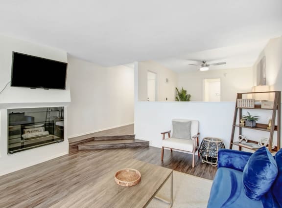 a living room with a fireplace and a tv