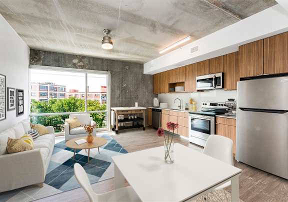 A modern kitchen with a dining table and chairs.