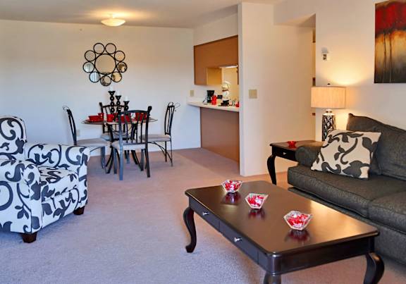 a dining room and kitchen with a table and chairs