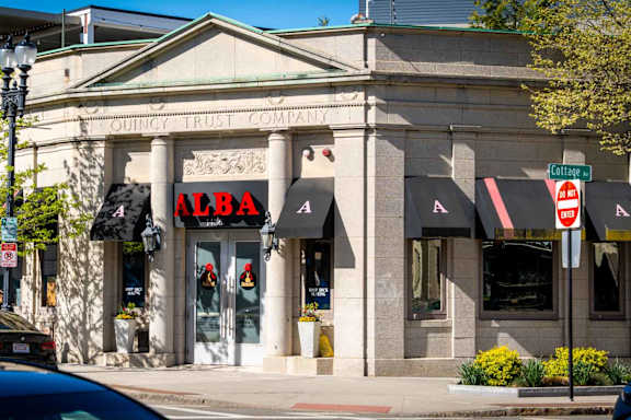 A building with a red sign that says Alba.