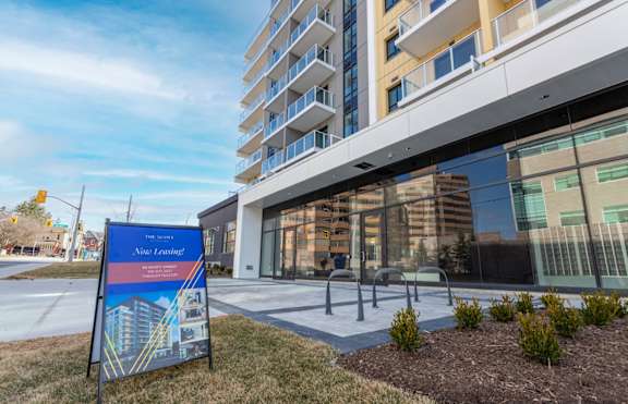 A sign for The Summit at Nine Lakes is displayed in front of a modern building.