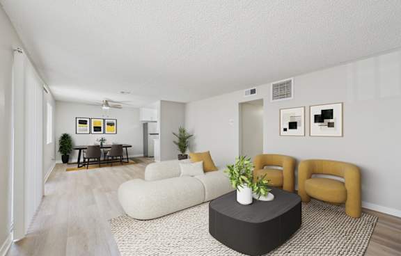 A living room with a white couch, a black coffee table, and a rug.