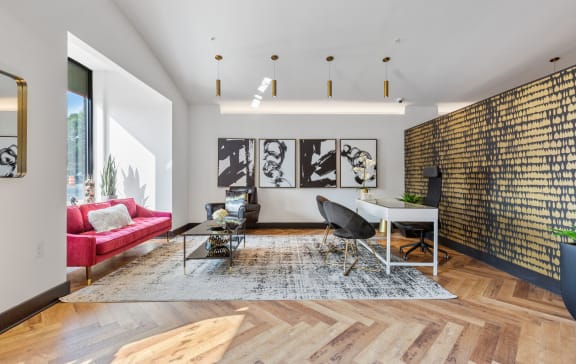 a living room with a couch and a table with a chair at Rialto, Washington, DC