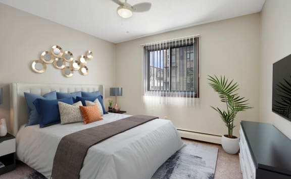 a bedroom with a bed and a ceiling fan