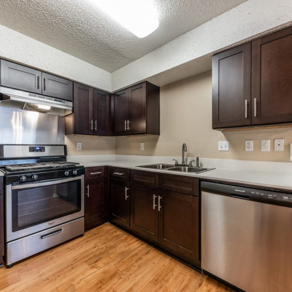 a kitchen with stainless steel appliances and wooden cabinets