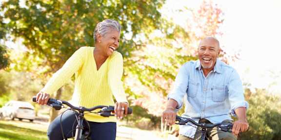 An older couple riding bikes together on a sunny day.at The Rosalyn | Affordable 55+ Apartments in Bloomington, Bloominton, MN