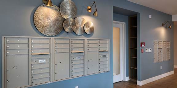 A wall of mailboxes in a hallway.