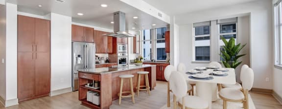 a kitchen and dining room with a table and chairs
