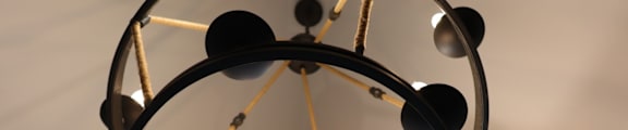 A chandelier with multiple lights and spheres hanging from the ceiling.