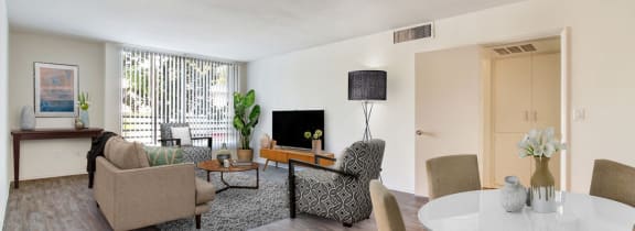 a living room with a table and chairs and a couch