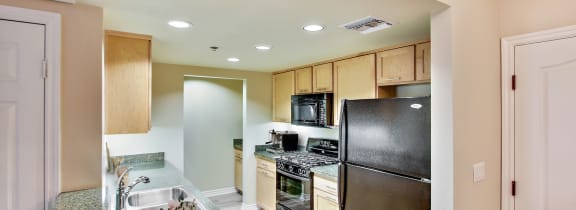 a kitchen with stainless steel appliances and granite counter tops