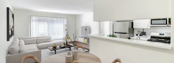 a living room with a table and a couch and a kitchen