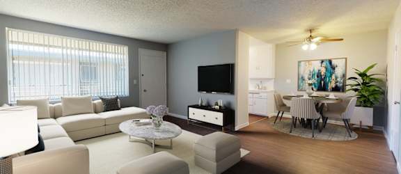 A living room with a white couch and a television.