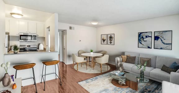 a living room with two beds and a couch and a table