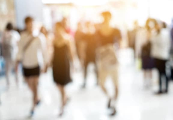 a crowd of people walking in a room