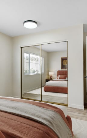 a bedroom with a bed and a mirror