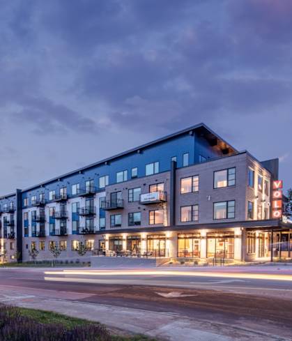 a large building with many windows and a street in front of it at Texa Tonka Apartments , Minnesota