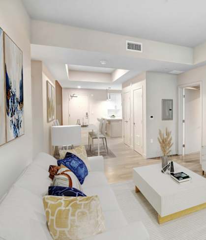 a living room with a white couch and a television