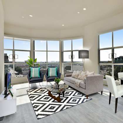 A modern living room with a large window overlooking the city.