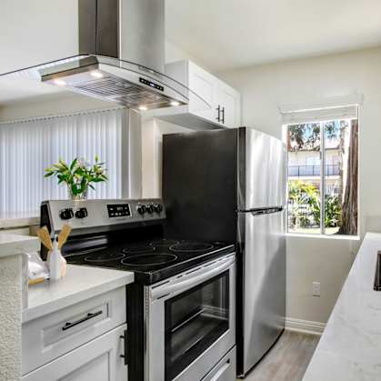 a kitchen with stainless steel appliances and white cabinets