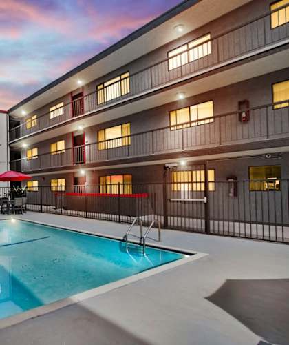 A swimming pool in a courtyard surrounded by buildings.