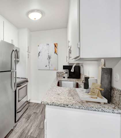 a kitchen with stainless steel appliances and granite counter tops