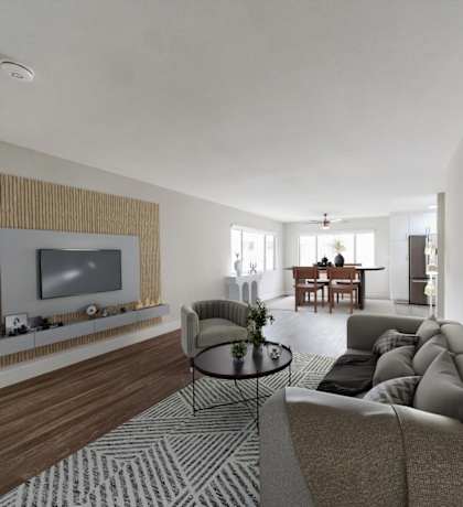 A modern living room with a grey sofa and a television.
