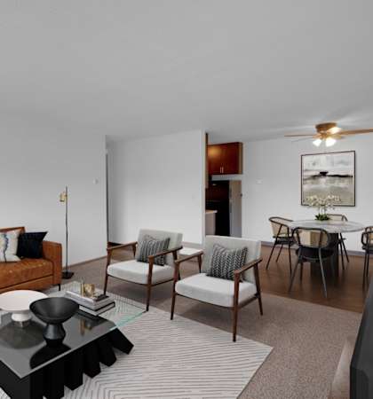 a living room with a couch chairs and a coffee table