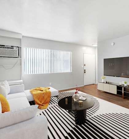 a living room with a white couch and a zebra rug
