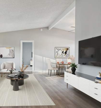 A modern living room with a white sofa and a coffee table.