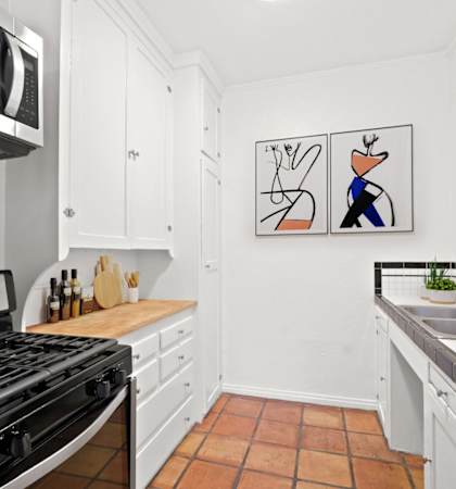 a kitchen with a stove and a sink and a microwave