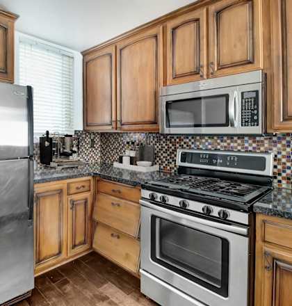 a kitchen with stainless steel appliances and wooden cabinets