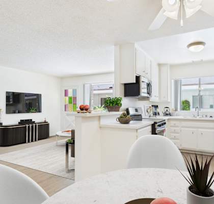 A modern kitchen with white cabinets and appliances.