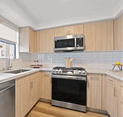 a kitchen with a sink and a stove and a microwave