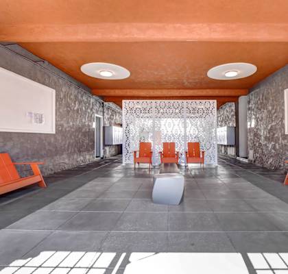 a long corridor with gray walls and an orange ceiling