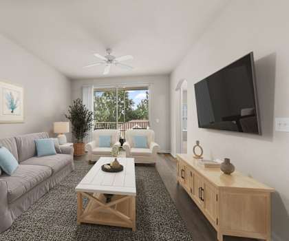 A living room with a grey couch, a wooden coffee table, and a flat screen TV mounted on the wall.