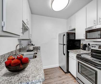 a kitchen with stainless steel appliances and granite counter tops