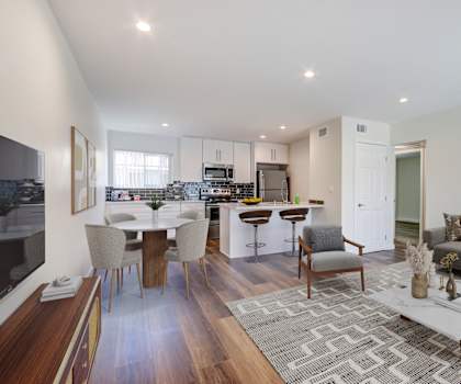 a living room with a kitchen and a dining room