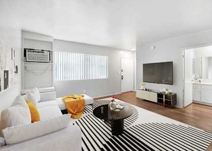 a living room with a white couch and a zebra rug