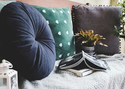 a bed with pillows and a book on it