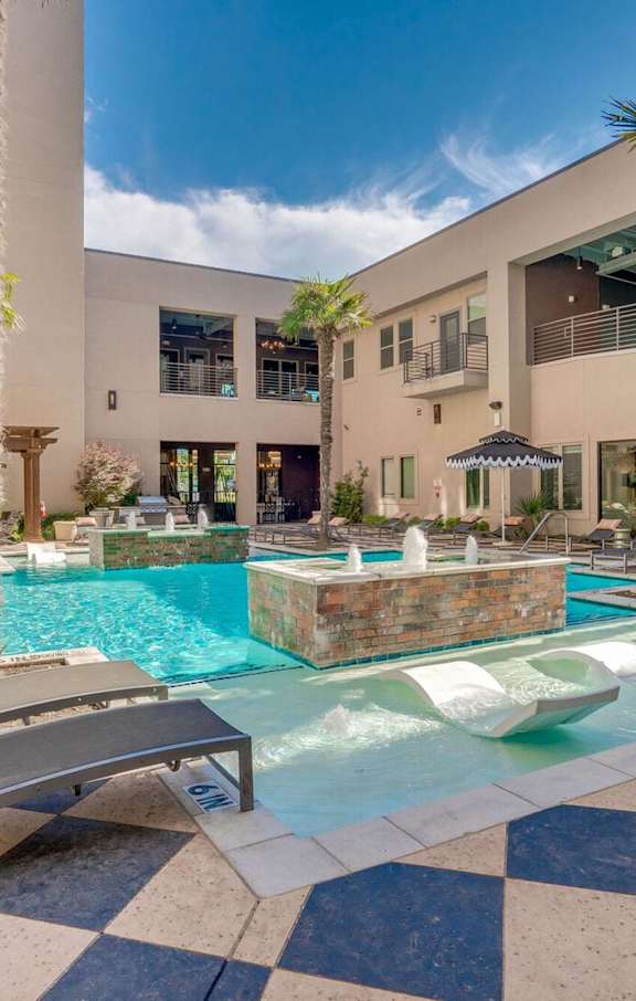A pool surrounded by a black and white checkered floor.