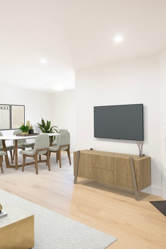a living room with a white couch and a table with chairs