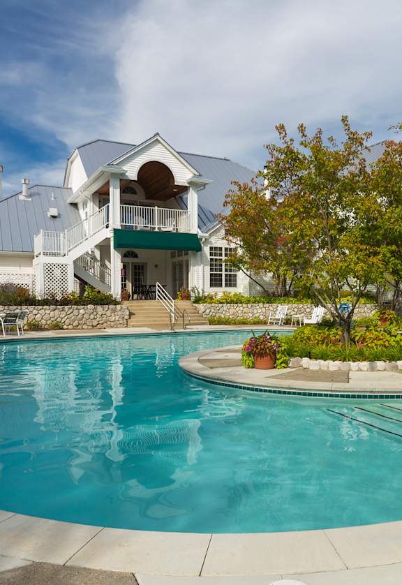 A large outdoor swimming pool with a building in the background.