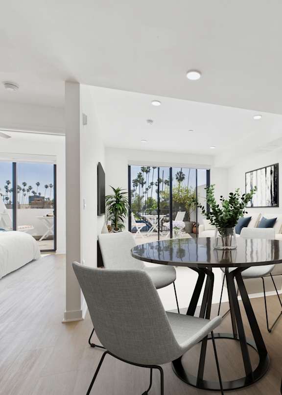 A white laundry room with a washer and dryer stacked on top of each other.