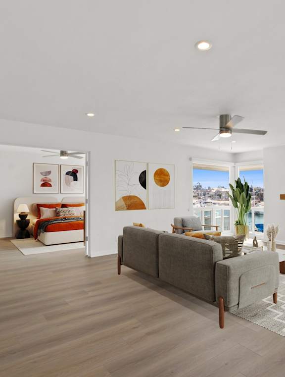 a living room with white couches and a fireplace