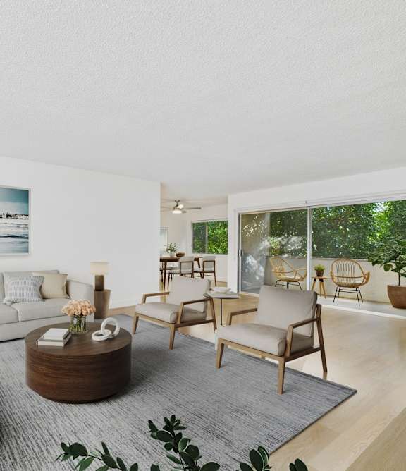 A living room with a white couch, a wooden table, and a rug.